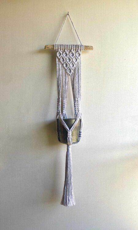 Diamond pattern macrame plant hanger on driftwood