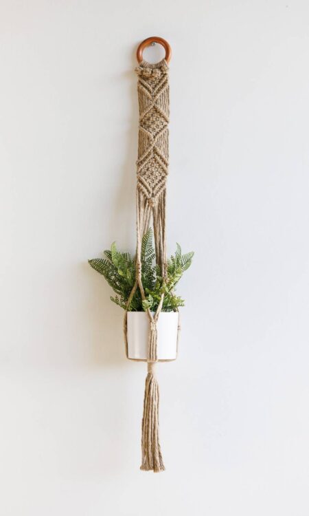 Brown macrame plant hanger with reclaimed wood curtain ring