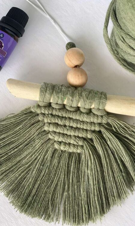 Green macrame on driftwood for rearview mirror with oil diffuser